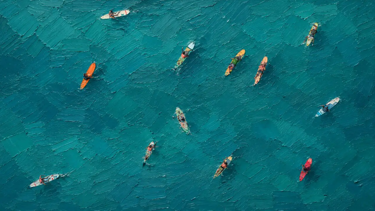 Oil painting from above of paddleboards on turquoise water